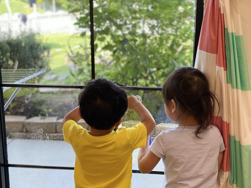 Toddlers staring out the window of Lifetime Montessori School