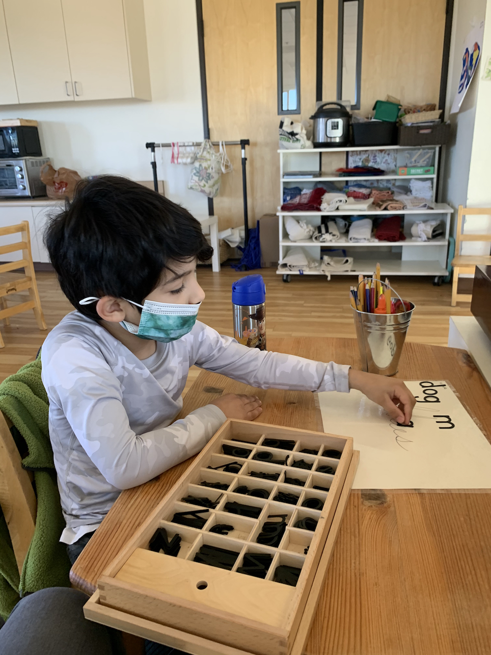 Elementary Montessori Child Working on Writing Skills Independently