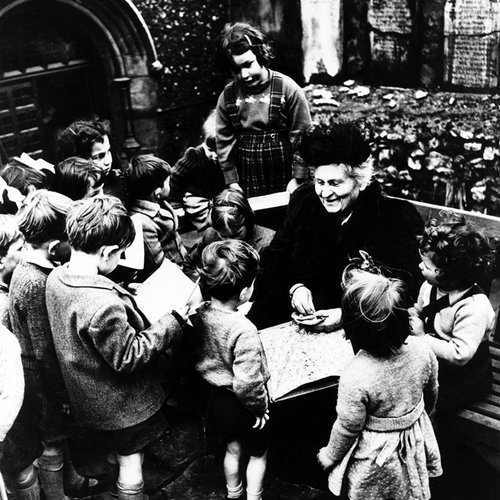 Maria Montessori working with children Maria Montessori