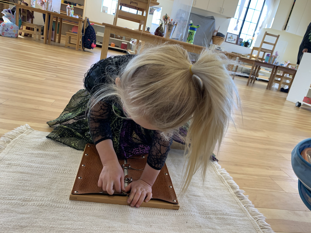 Montessori Baby learning to close a buckle
