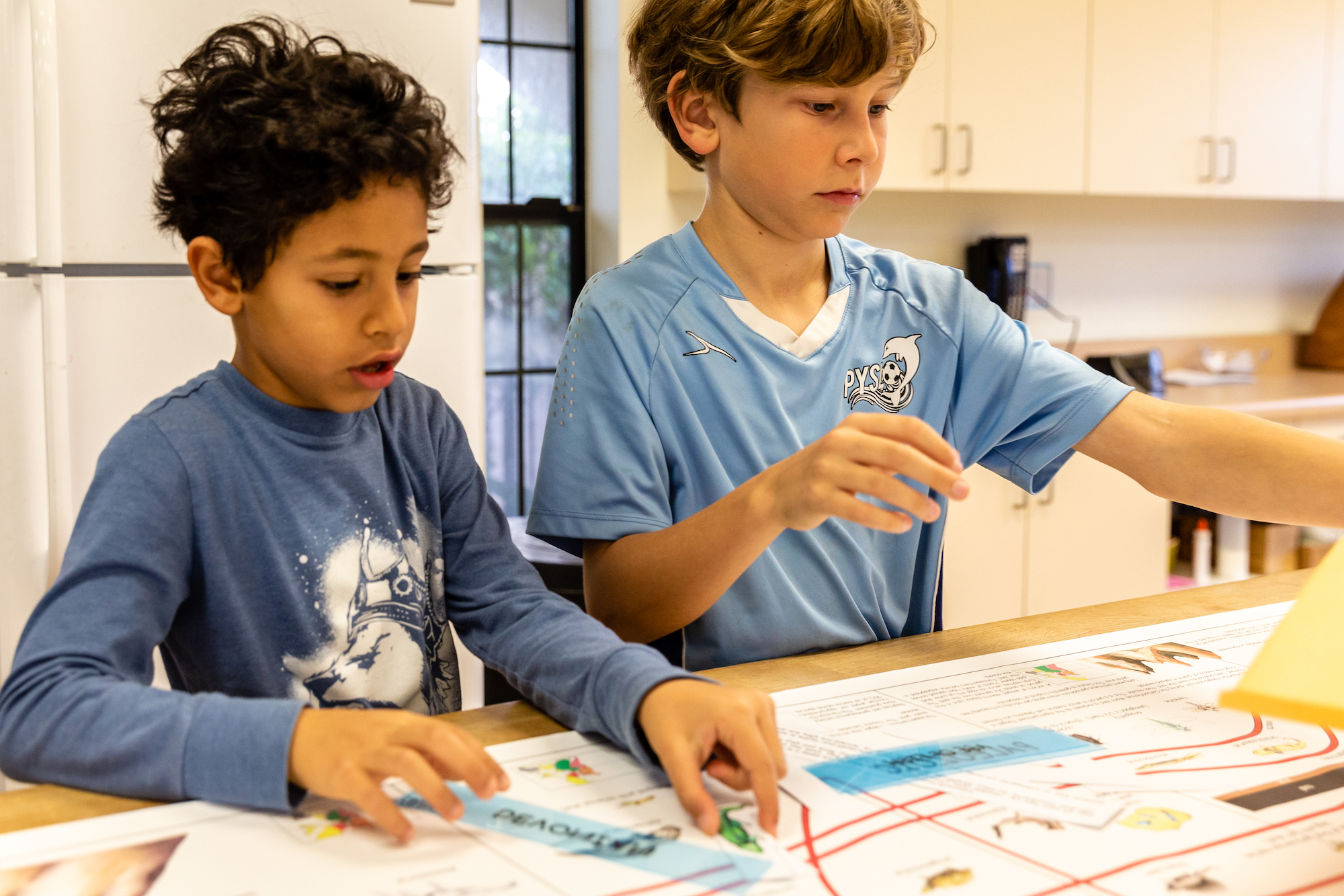 Two Elementary Montessori children solving problems