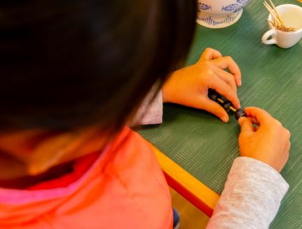 Girl placing blueberries in toothpick