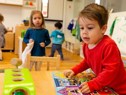 Montessori classroom with children playing and having fun