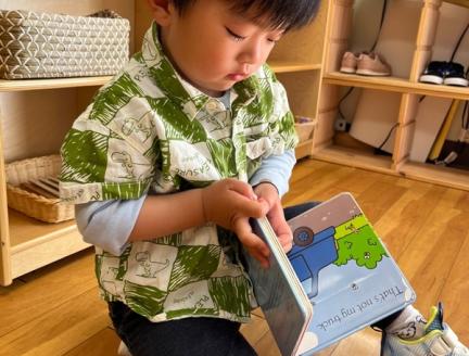 reading a book during potty training at Lifetime Montessori School in Santaluz