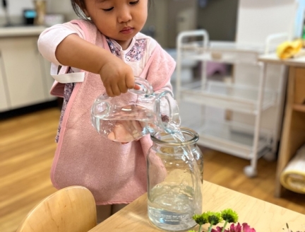 Toddler doing it 'all by myself cutting plants independently.