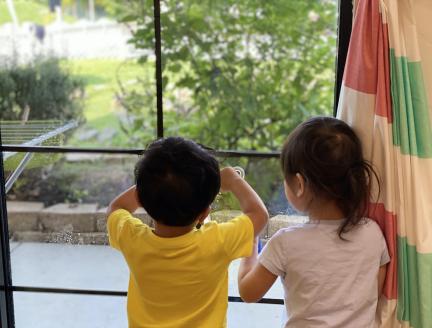 Toddlers staring out the window of Lifetime Montessori School