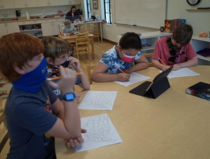 Elementary Montessori Students in San Diego working on Geography with limited technology