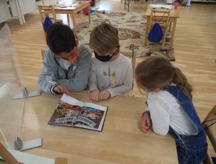 Three Montessori Elementary children learning together