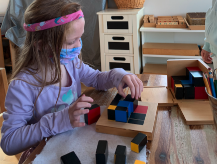 Montessori Primary Student working on a puzzle
