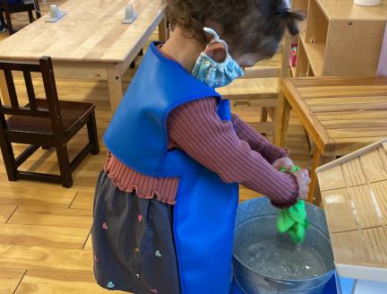Child doing chores builds their self esteem at Lifetime Montessori school