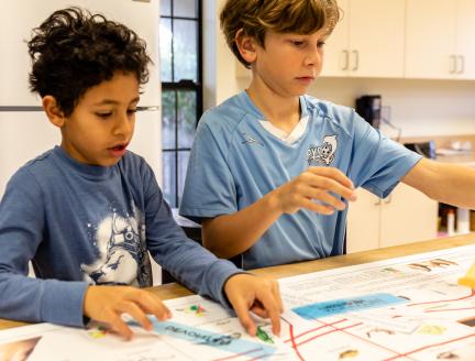 Two Elementary Montessori children solving problems