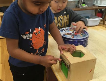 Child figuring out how a box works
