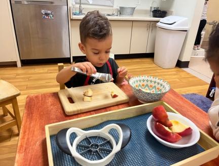 Child making breakfast independently at Lifetime Montessori school in Santaluz