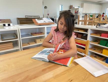 Child learning and working independently at Lifetime Montessori School