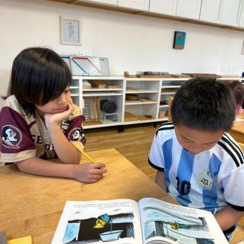 Elementary Children working together reading at Lifetime Montessori School in San Diego, Highly rated for Best Montessori School in San Diego