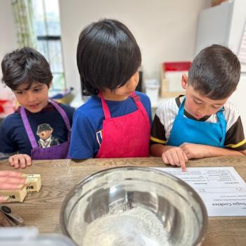 Elementary Children reading recipes together at Lifetime Montessori School in San Diego, Highly rated for Best Montessori School in San Diego