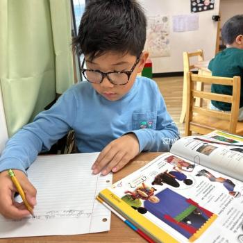Elementary Child reading at Lifetime Montessori School in San Diego, Highly rated for Best Montessori School in San Diego
