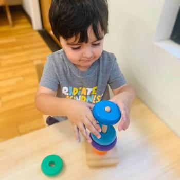 Toddler independently learning shapes and puzzles at Lifetime Montessori School 