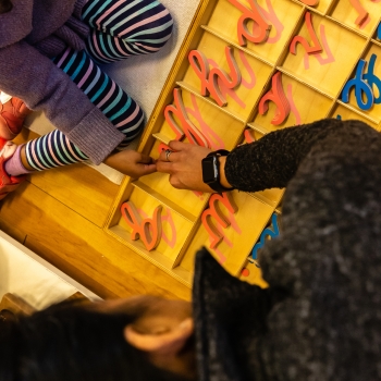 Individualized learning with cursive letters at Lifetime Montessori School in San Diego