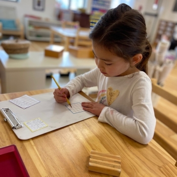 Elementary Child solving math problems at Lifetime Montessori School in San Diego