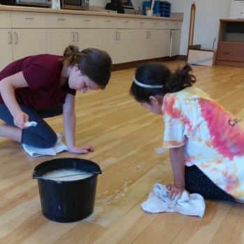 Two Girls Independently Cleaning Classroom