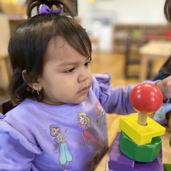 Toddler independently learning shapes and puzzles at Lifetime Montessori School 