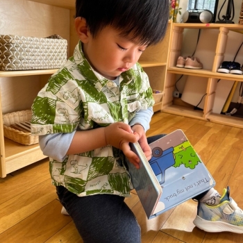 Toddler independently reading at Lifetime Montessori School 