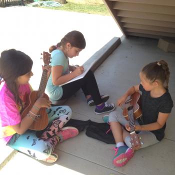 Elementary Montessori children playing music