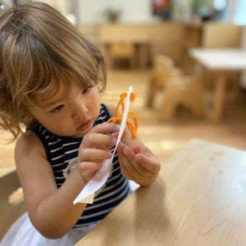 Toddler independently sewing at Lifetime Montessori School 