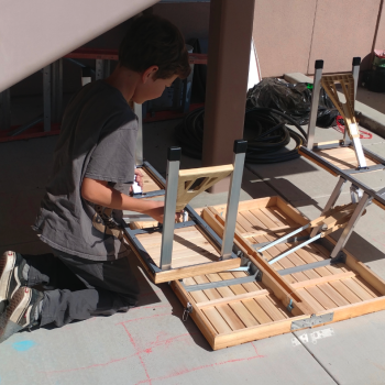 Elementary boy fixing a table at Lifetime Montessori school Engineering