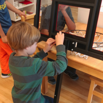 Elementary children installing basketball hoop at Lifetime Montessori school Engineering