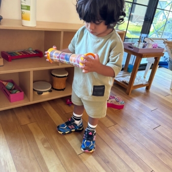 Toddler independently learning shapes and puzzles at Lifetime Montessori School 